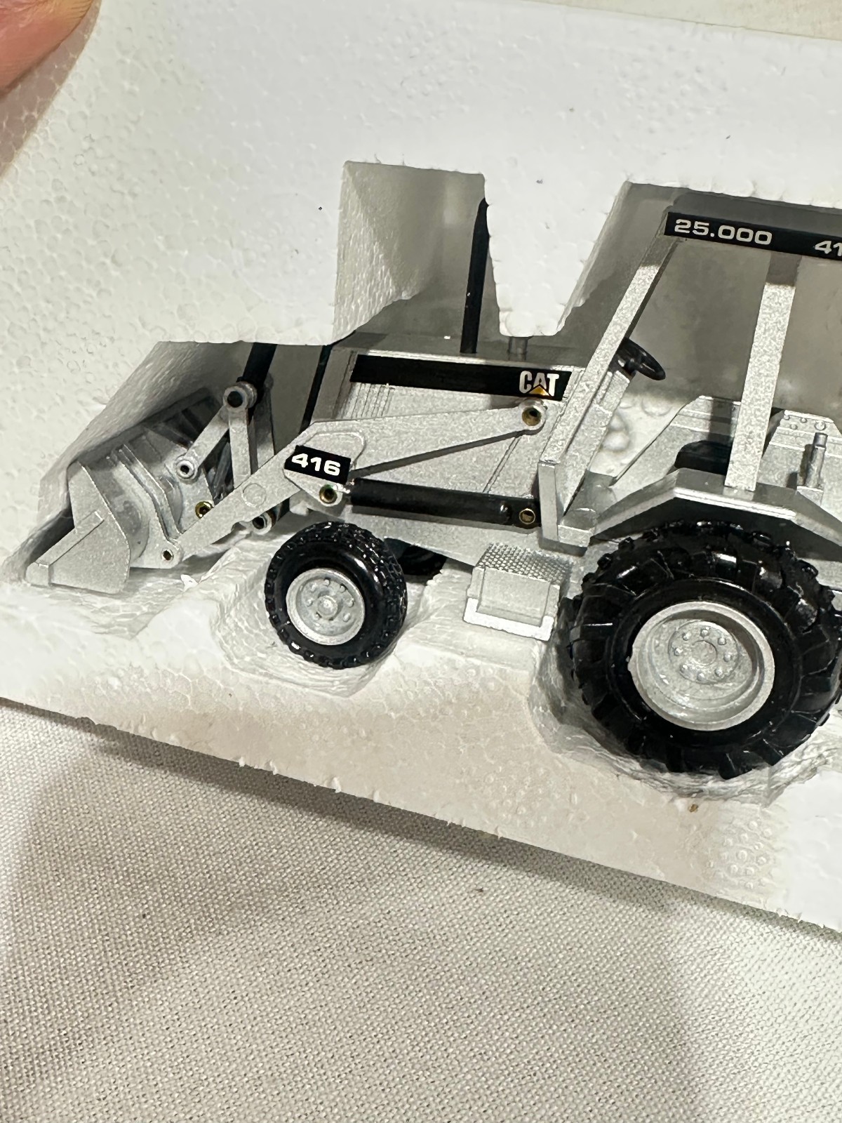 Caterpillar 416 Backhoe Loader 25,000th Silver Edition By NZG 1/50th Scale