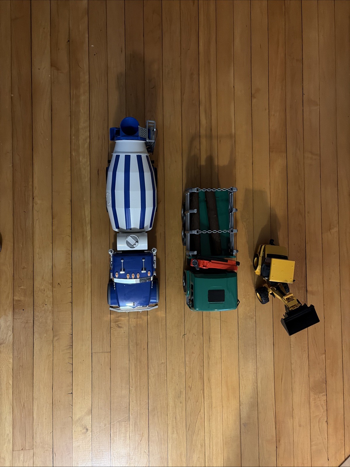 Lot Of Three Bruder Trucks Logger, Cement Truck, Cat Bucket Loader