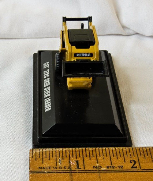 Norscot Group Inc. CAT 272C Skid Steer Loader on stand -missing front wheels