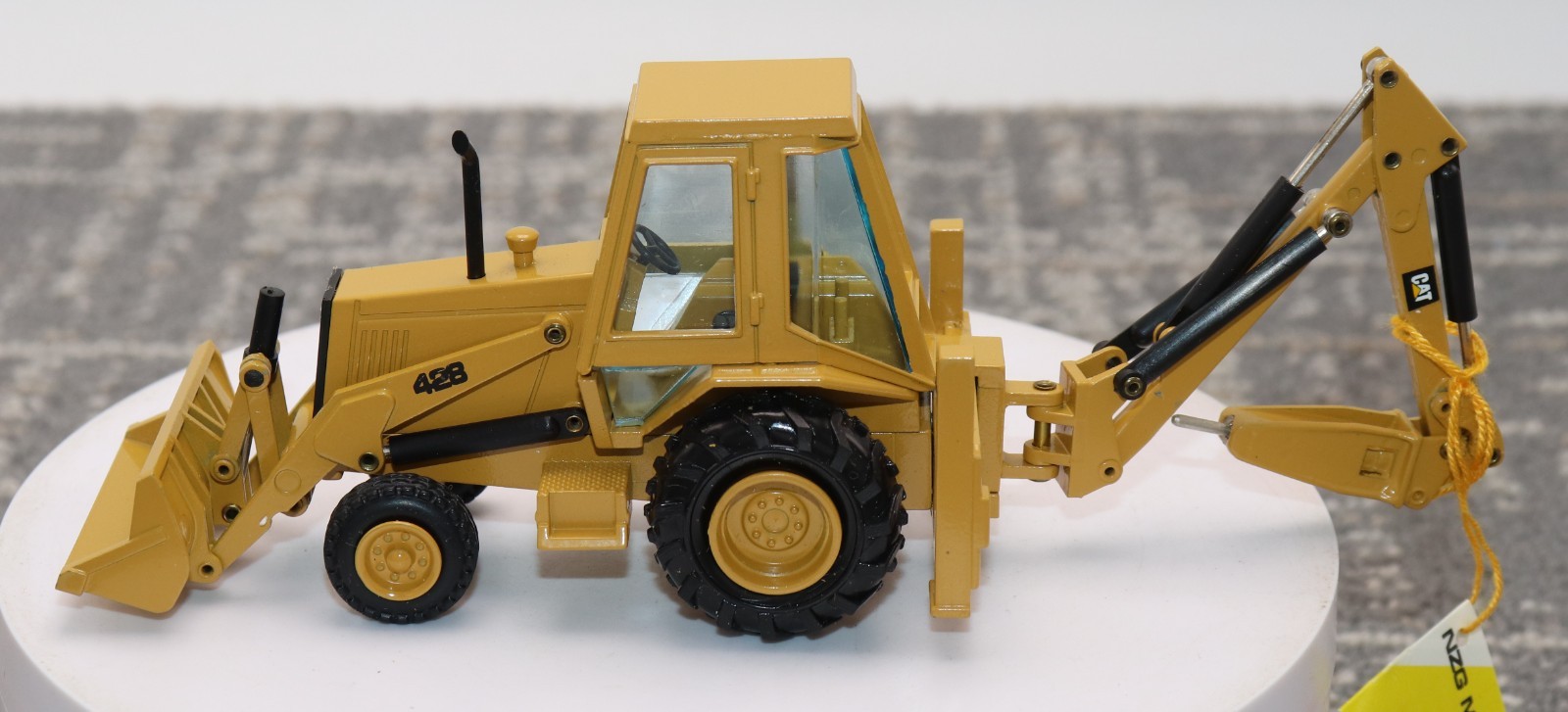 NZG CAT 428 Backhoe Loader Hydraulic Hammer #378/1 Caterpillar 1:50 Scale in Box
