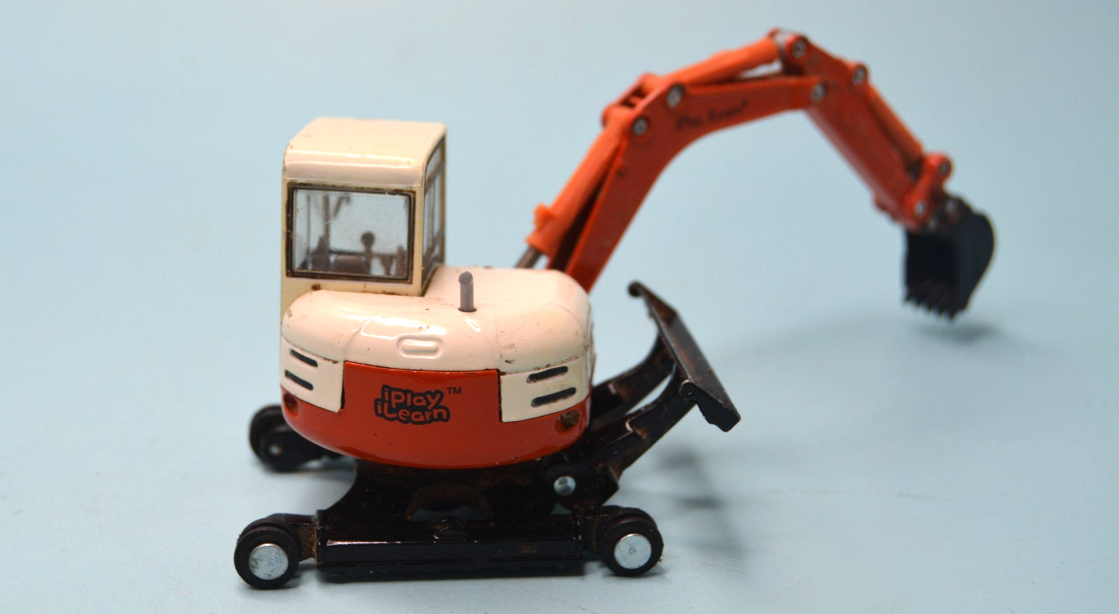 Diecast orange mini-track backhoe excavator