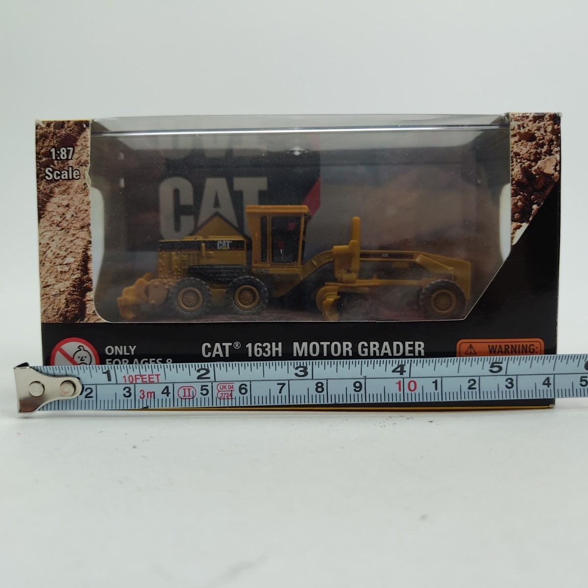 NORSCOT CAT 1:87 HO 163H Motor Grader At Work (Yellow) Diecast Caterpillar 55437