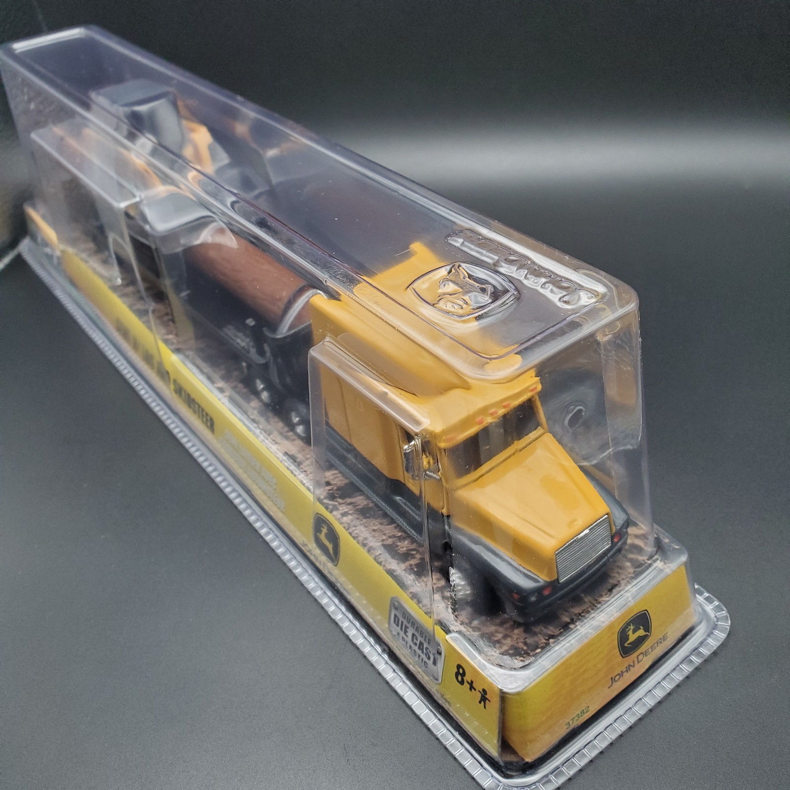 JOHN DEERE – ERTL SEMI W/ LOG AND SKIDSTEER 37382