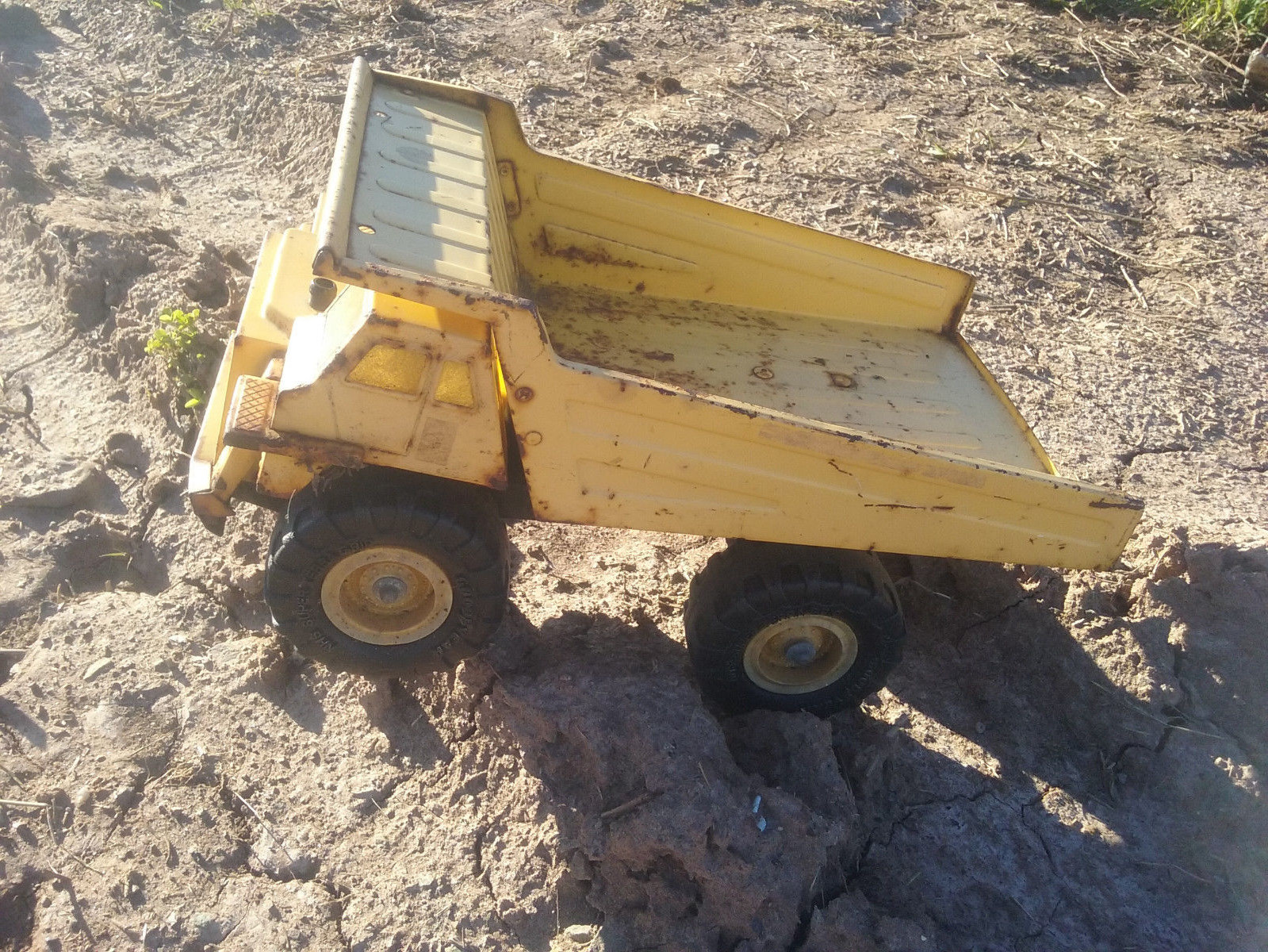 Yellow Metal Dump Truck Goodyear Super Terra Grip Tires 1986 REMCO Toys, Inc.
