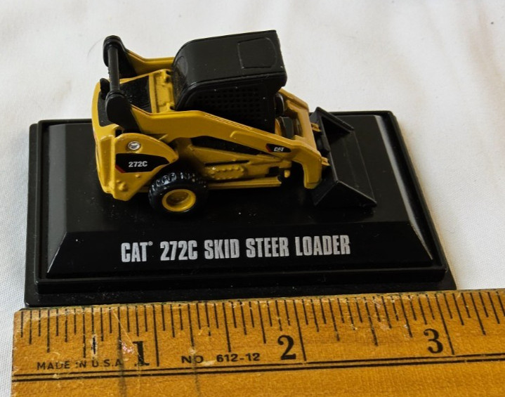 Norscot Group Inc. CAT 272C Skid Steer Loader on stand -missing front wheels