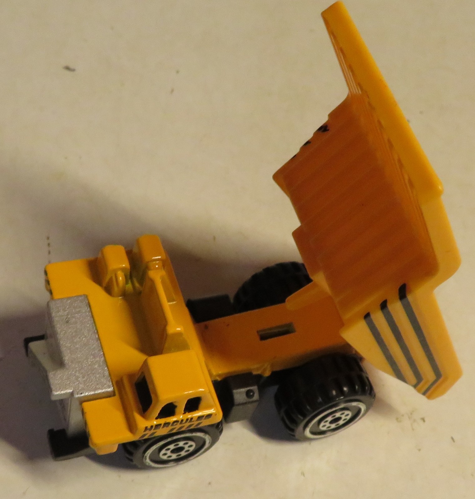 Hercules Classic Construction Toy 3″ Long Dump Truck Yellow Plastic Grading Haul