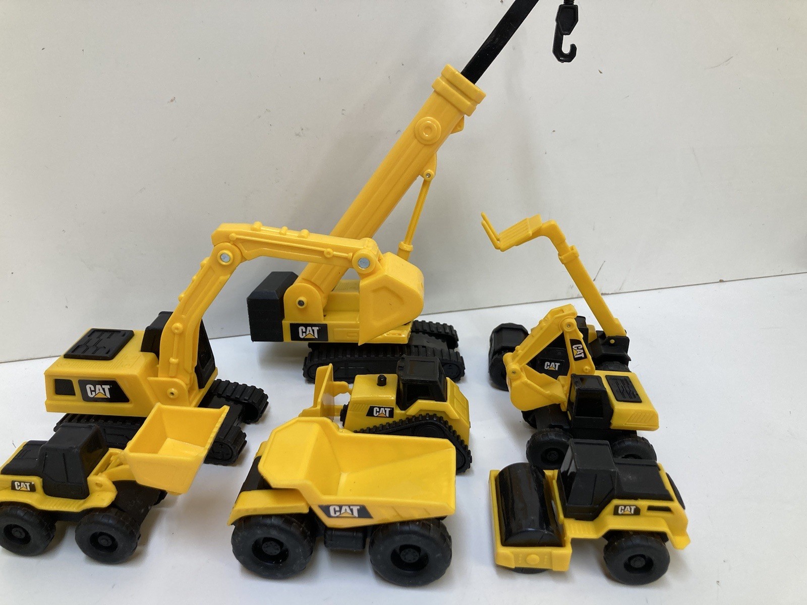 8 Small 3”-4” Long Plastic Toy Caterpillar Construction Trucks. Movable Parts