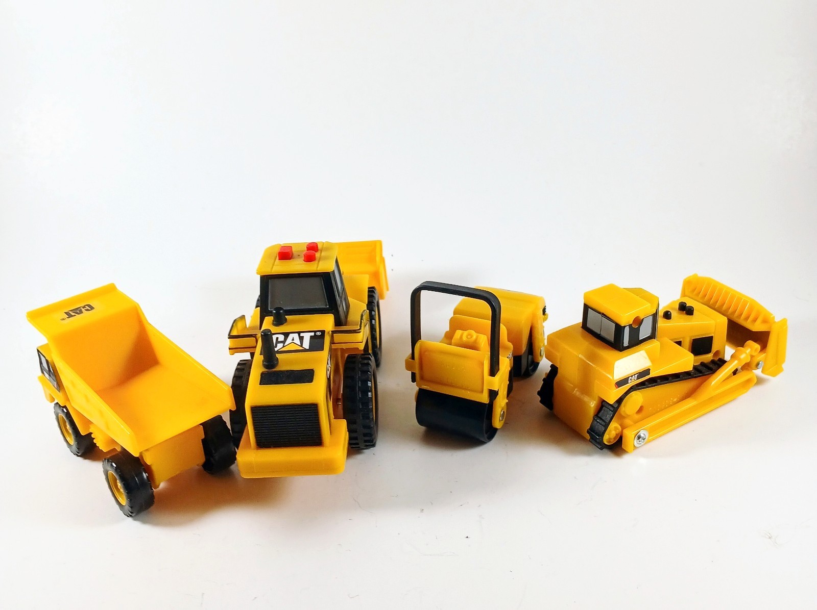 Vintage Set of 4 Caterpillar (CAT) Construction Vehicle Toys Between 2.5″-6″