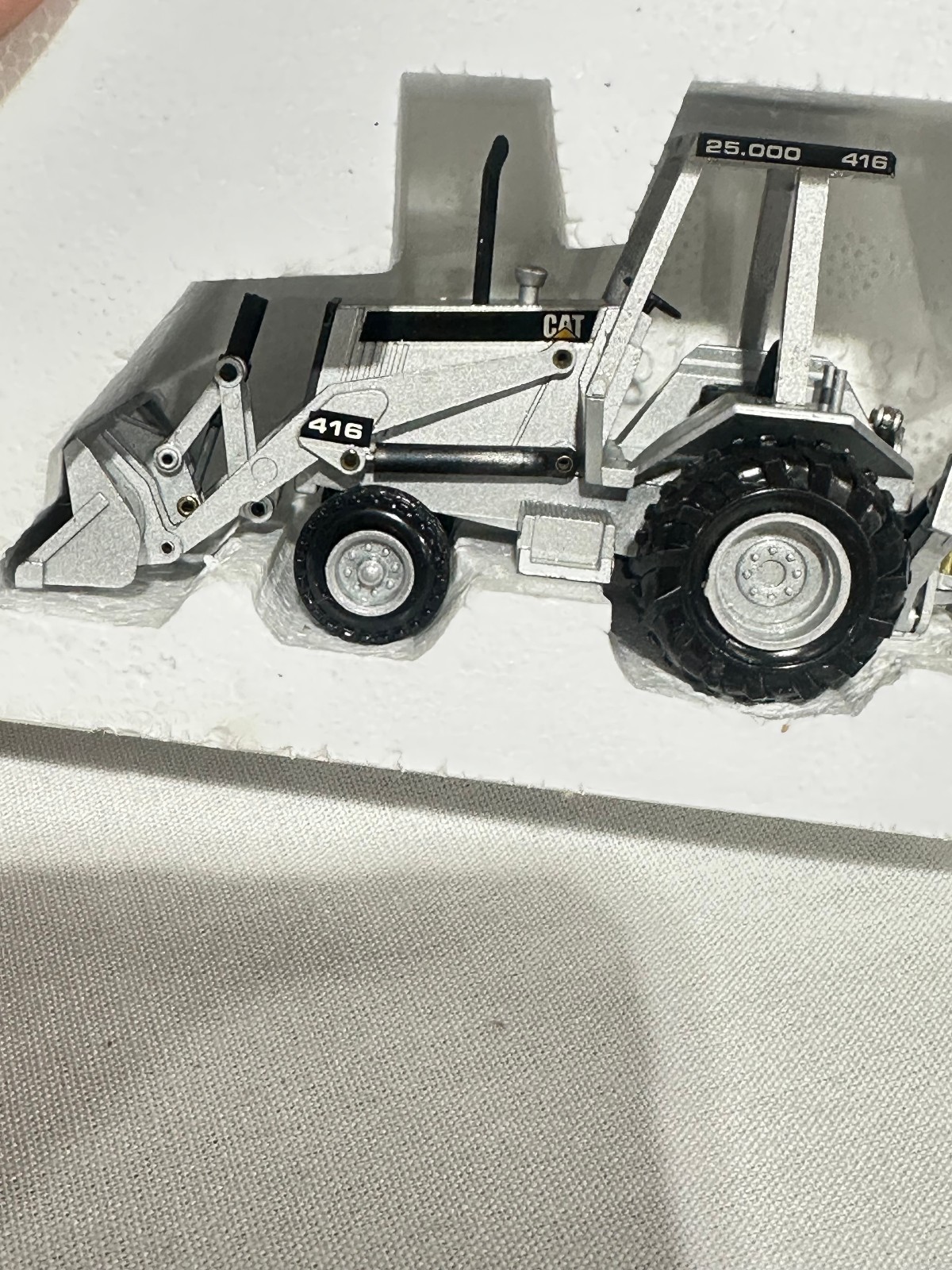 Caterpillar 416 Backhoe Loader 25,000th Silver Edition By NZG 1/50th Scale